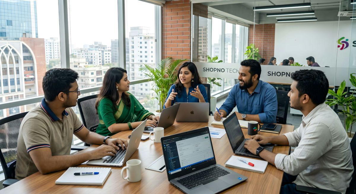 Design studio team collaborating around a table in a bright office Design studio team collaborating around a table in a bright office