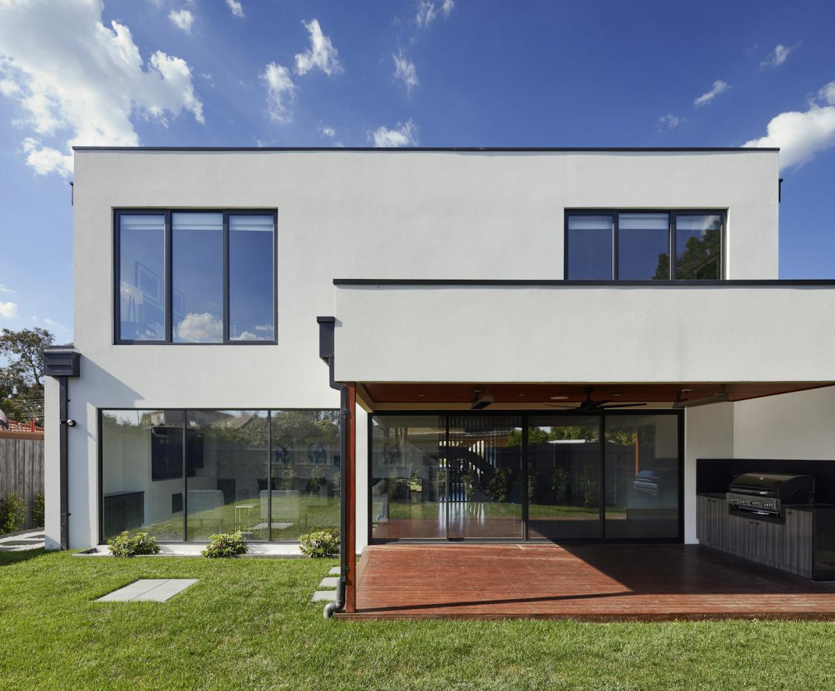 Modern home positioned on its site with landscaped lawn and open frontage