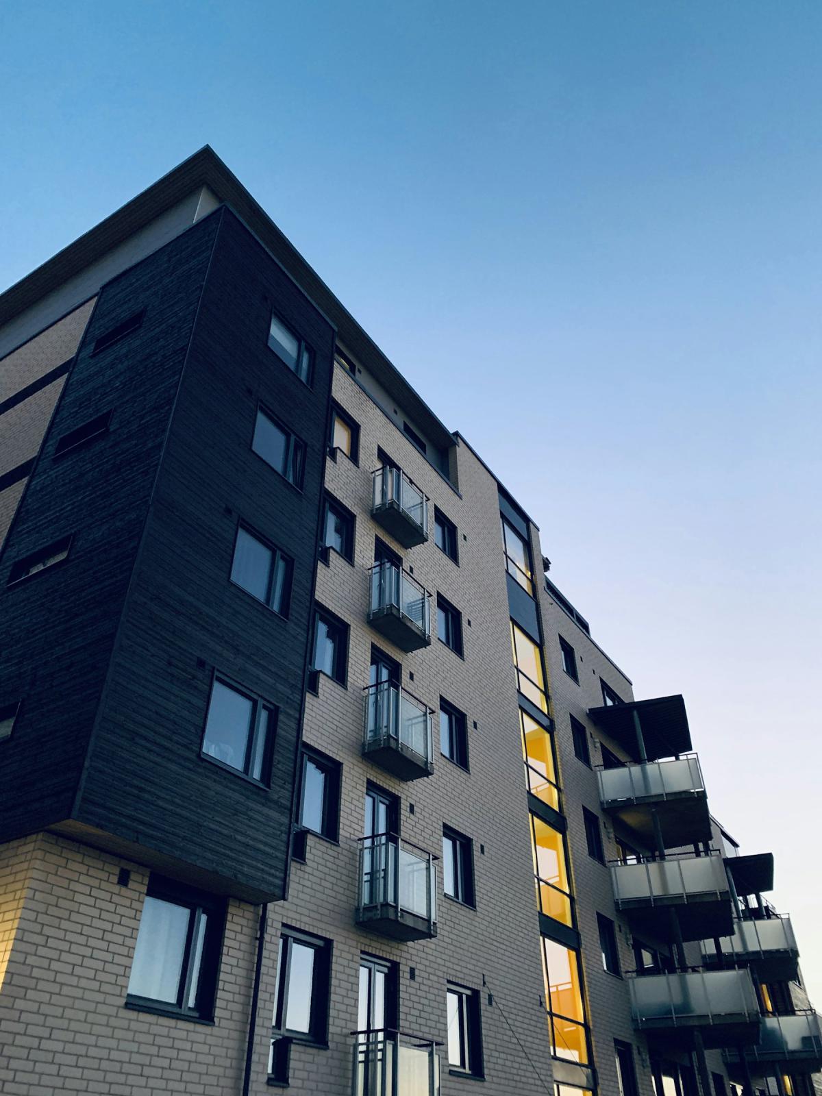 Apartment architecture with balconies and dark facade panels Apartment architecture with balconies and dark facade panels