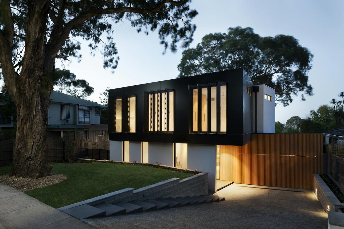 Contemporary home facade glowing with interior lights in the evening Contemporary home facade glowing with interior lights in the evening