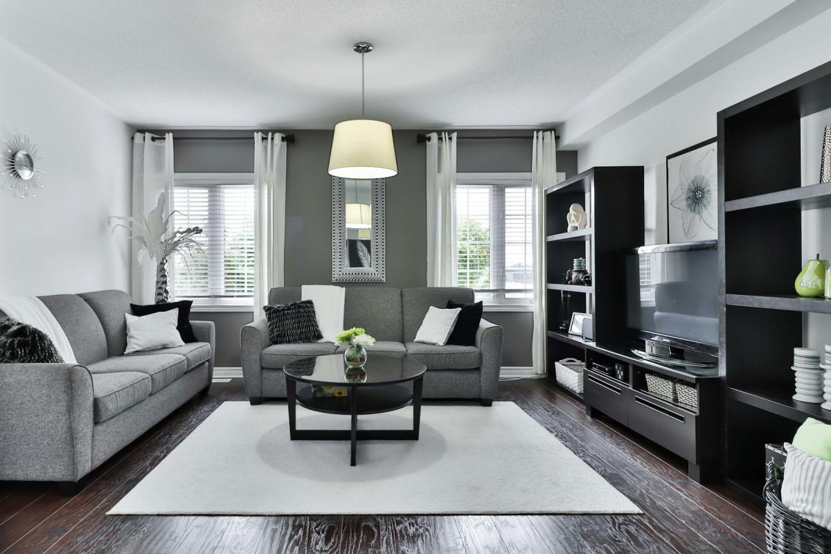 Premium apartment living room with grey upholstery and built-in shelving Premium apartment living room with grey upholstery and built-in shelving