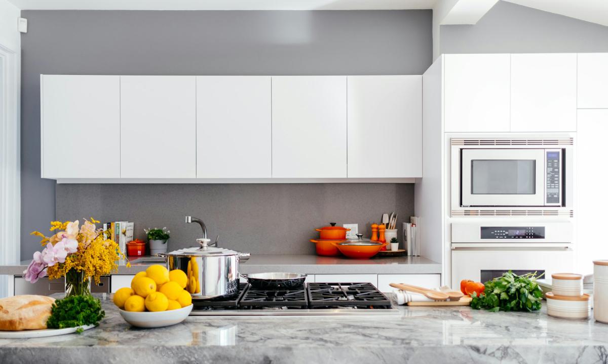 Open kitchen with quartz countertop and integrated appliances Open kitchen with quartz countertop and integrated appliances