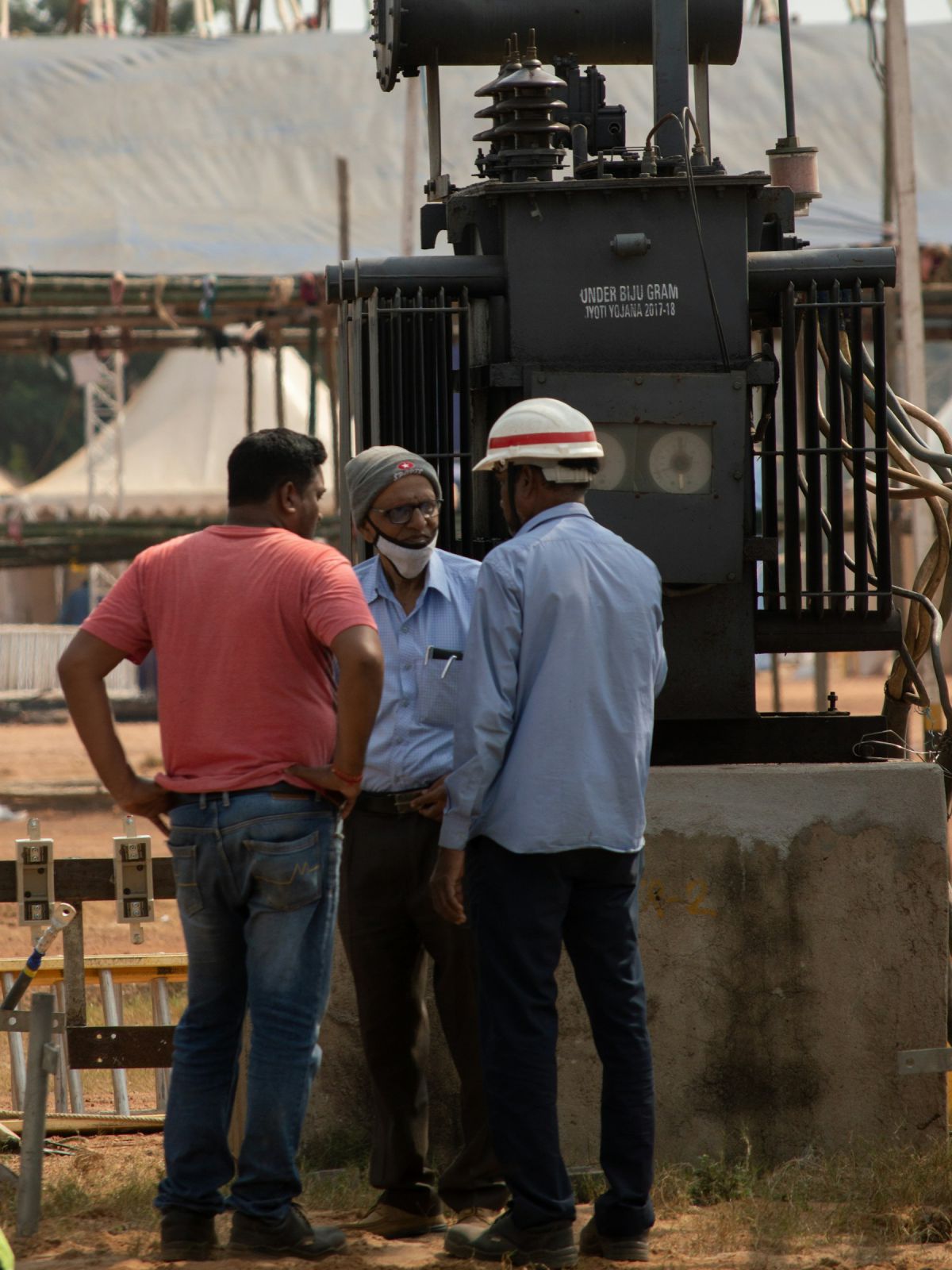 Site engineer in a safety helmet supervising work with the contractor team Site engineer in a safety helmet supervising work with the contractor team
