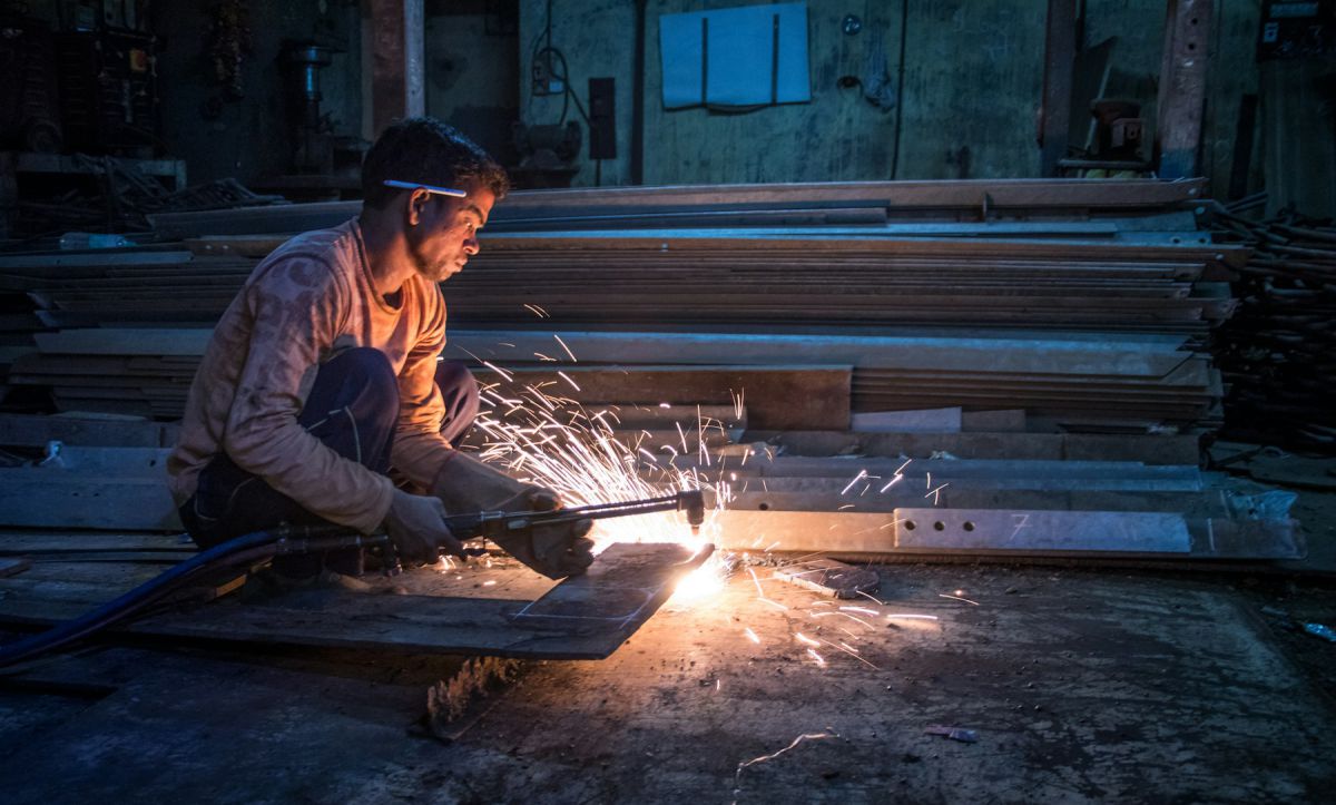 Fabricator welding steel with sparks during on-site fit-out work Fabricator welding steel with sparks during on-site fit-out work