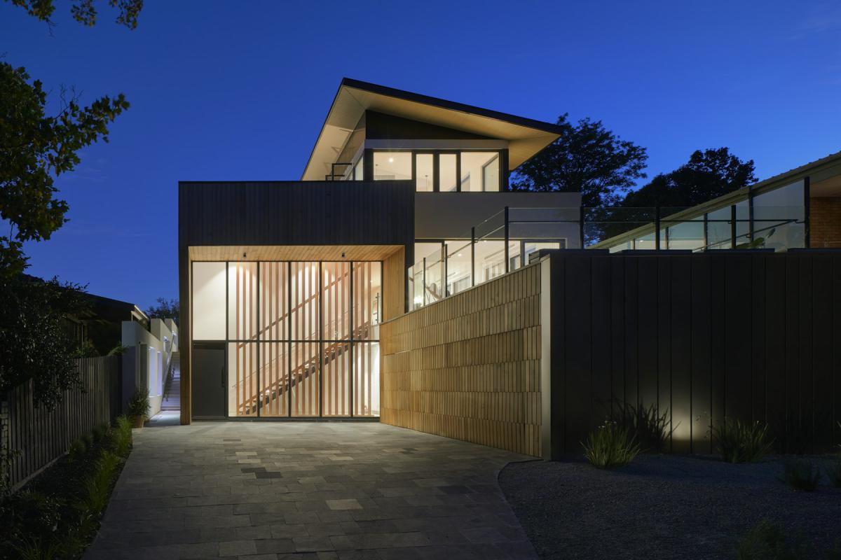 Villa exterior at night with timber screens and illuminated entrance